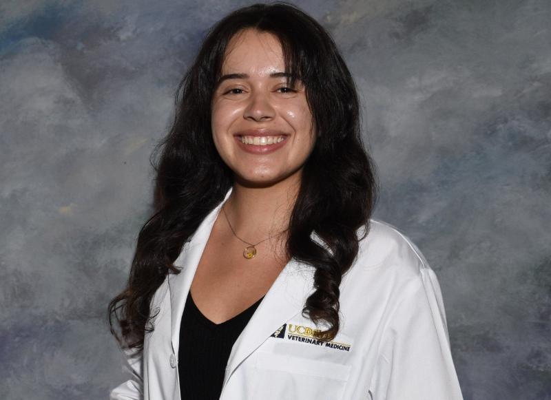 Kimberly Aguirre smiles in her white coat. 